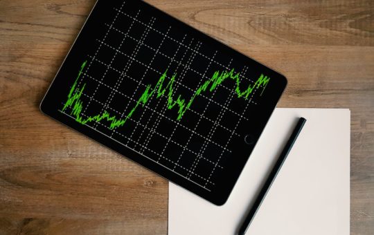 space grey ipad air with graph on brown wooden table