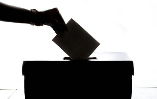 person dropping paper on box