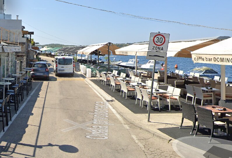 Obala prvoboraca sa štekatima uz sam rub kolnika i kombijem na cesti